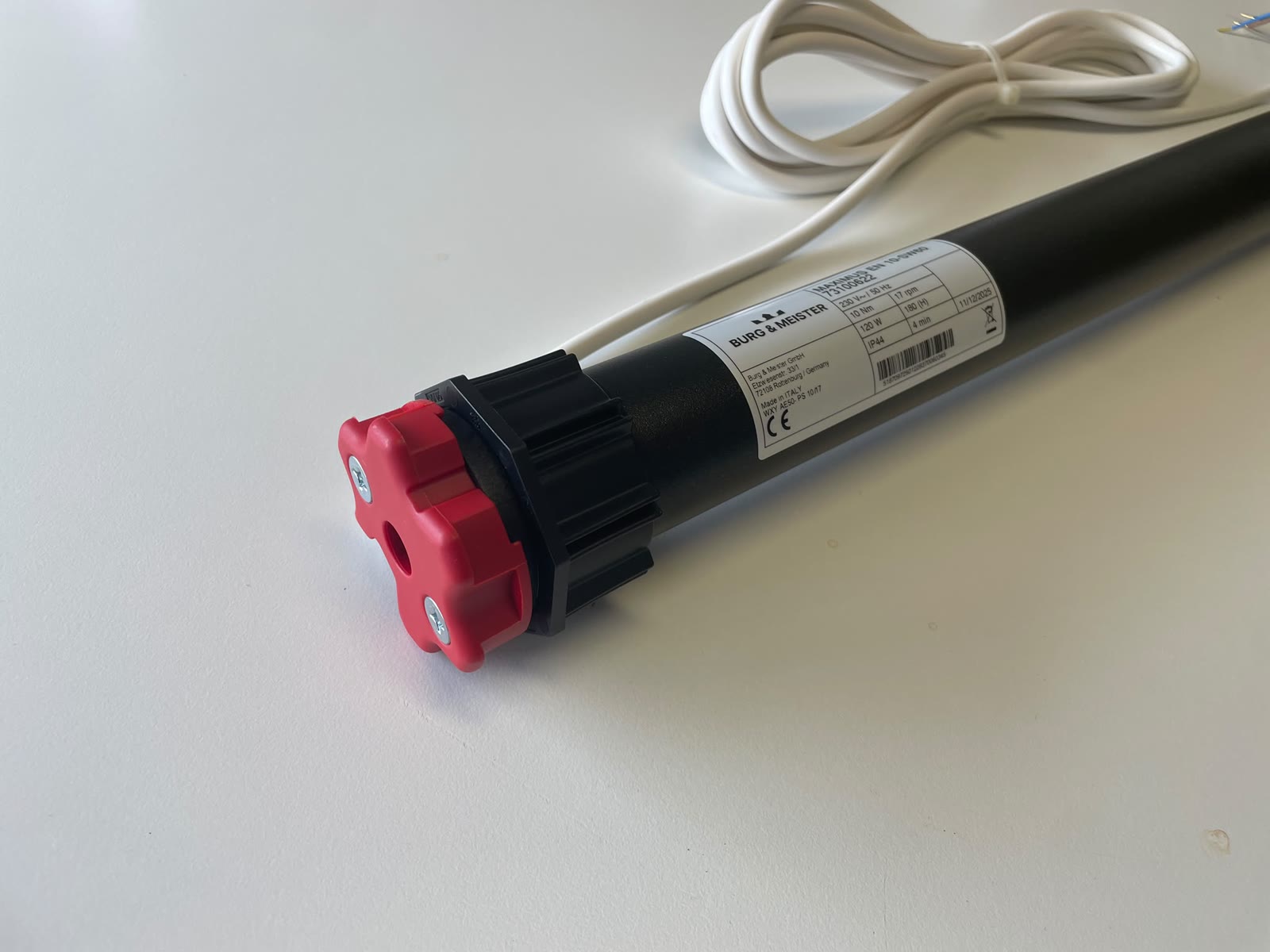 Nahaufnahme des Typenschilds auf dem schwarzen Motorrohr: Burg & Meister, MAXIMUS EN 10-SW60, Artikelnummer 73100622, 230 Volt Wechselstrom bei 50 Hertz, 10 Newtonmeter, 17 Umdrehungen pro Minute, 120 Watt, 4 Minuten Kurzzeitbetrieb, Wärmeklasse 180 H, Schutzart IP44, CE-Zeichen